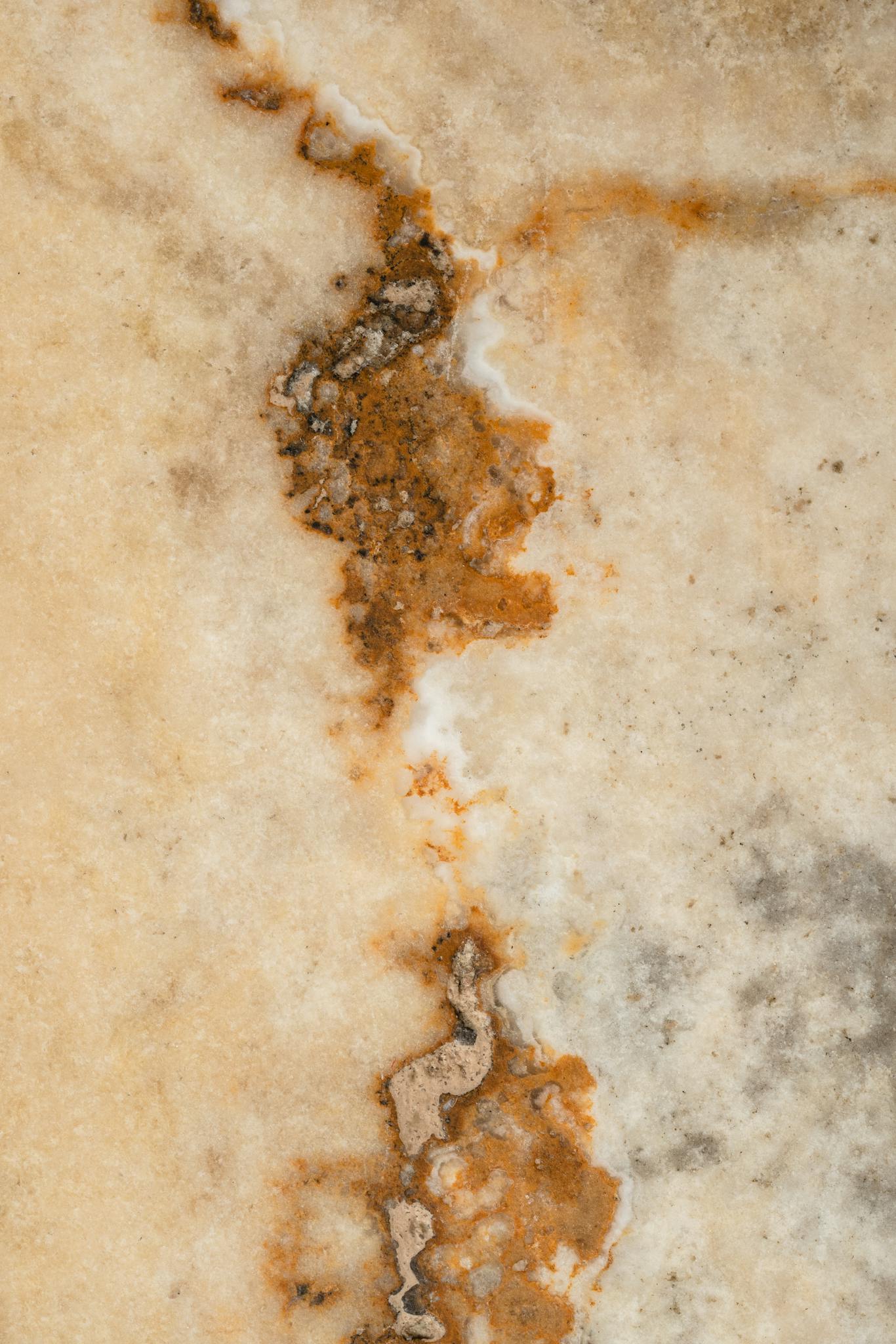 Close-up of a marble surface showcasing natural beige and brown textures for backgrounds.