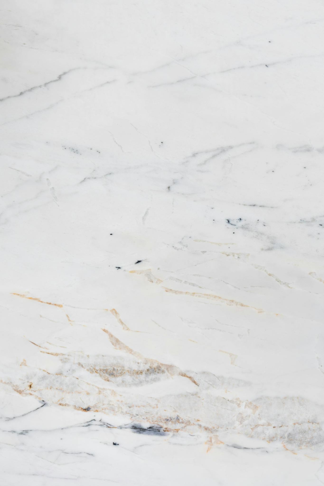 High-quality white marble surface with subtle and elegant veining detail, perfect for backgrounds.
